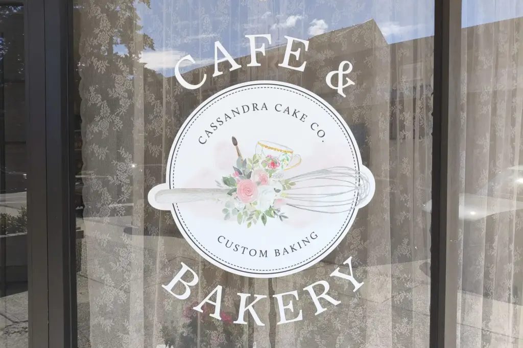 vinyl graphics on window that says Cafe and Bakery with a round logo